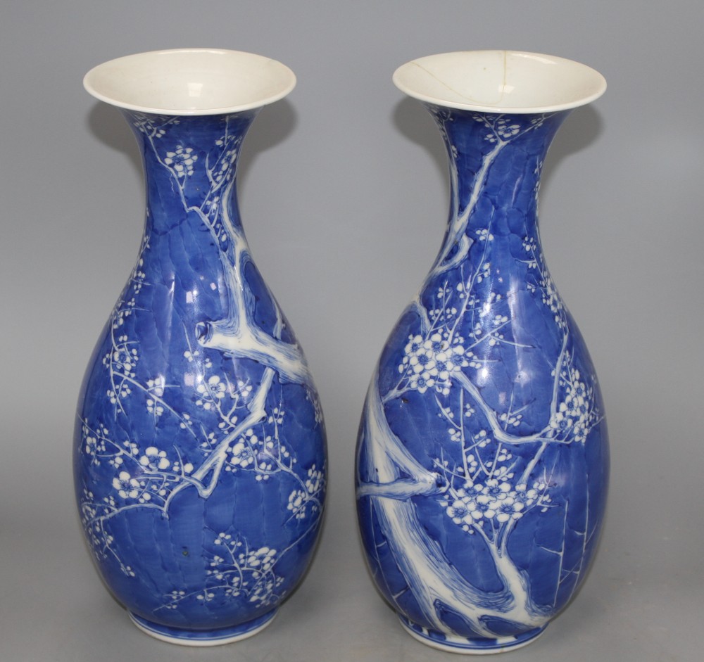 A pair of Japanese blue and white baluster vases, decorated with prunus trees, six character mark, height 31cm